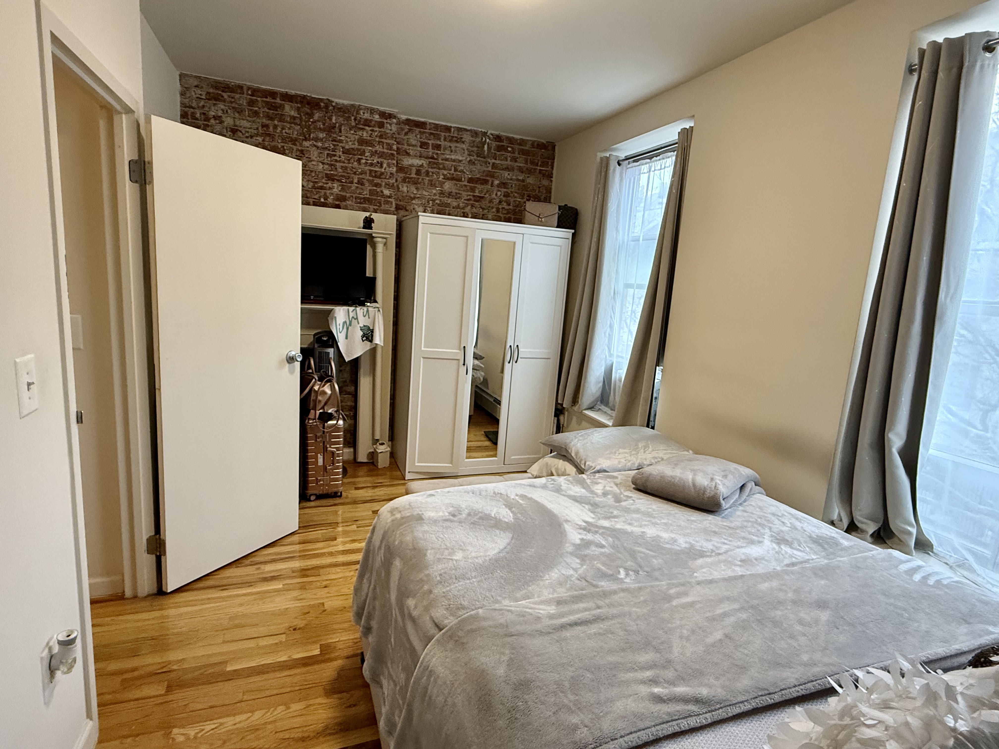 Convent Avenue Manhattan, NY 10031 - Photo 8 of 12 a bedroom with a bed and a large mirror