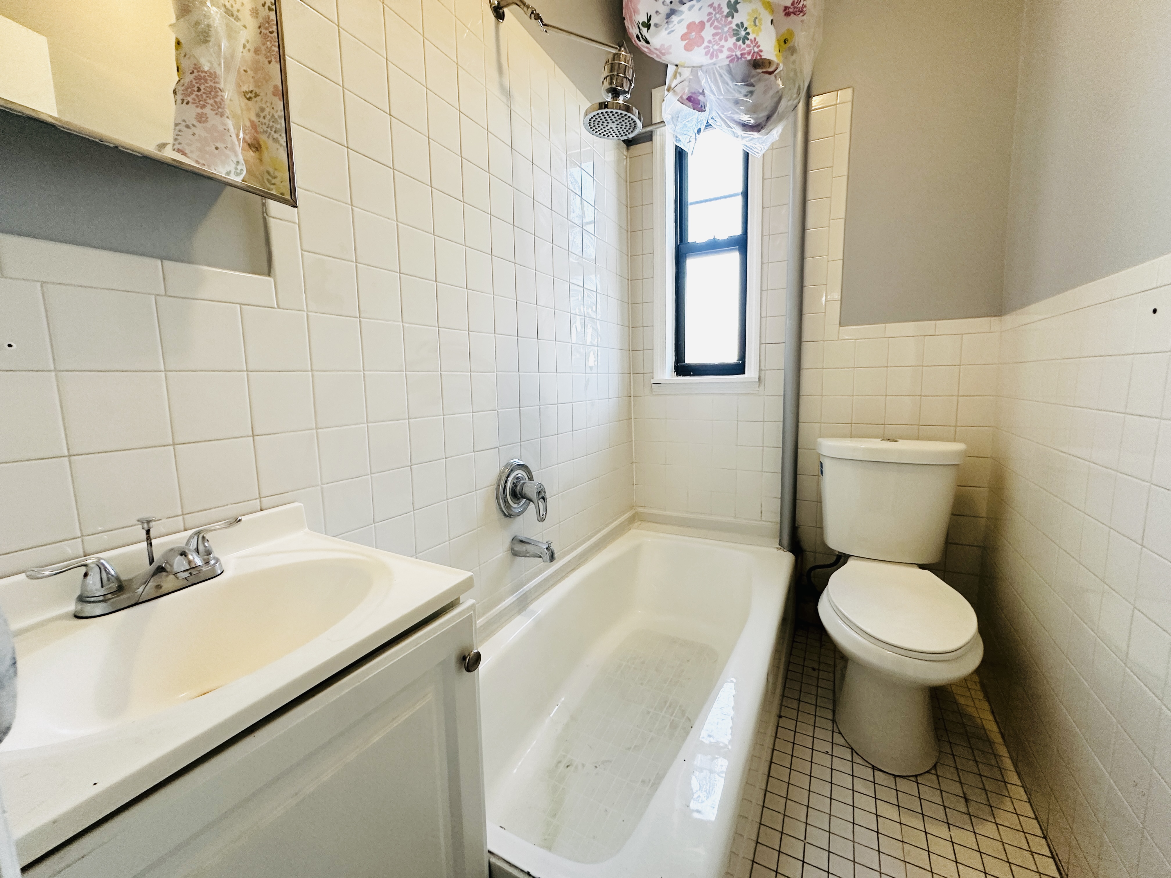 111 Lee Avenue, Unit 4B Brooklyn, NY 11211 - Photo 4 of 4 a bathroom with a sink toilet and a mirror