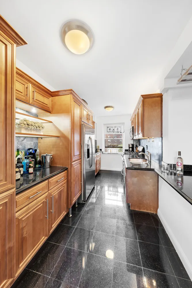 a kitchen with stainless steel appliances granite countertop a stove and cabinets