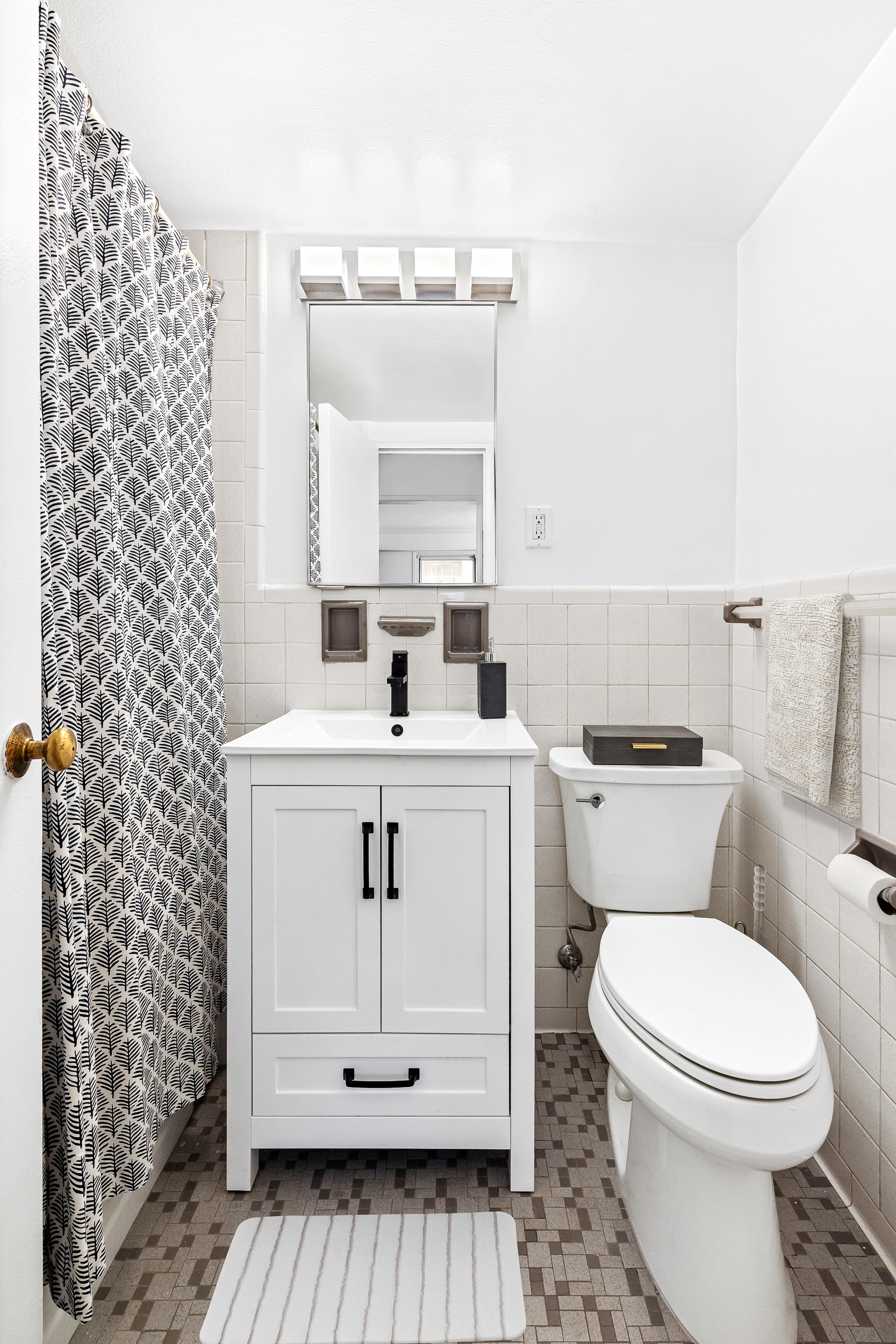 445 East 86th Street, Unit 12A Manhattan, NY 10028 - Photo 5 of 11 a bathroom with a sink a toilet and mirror