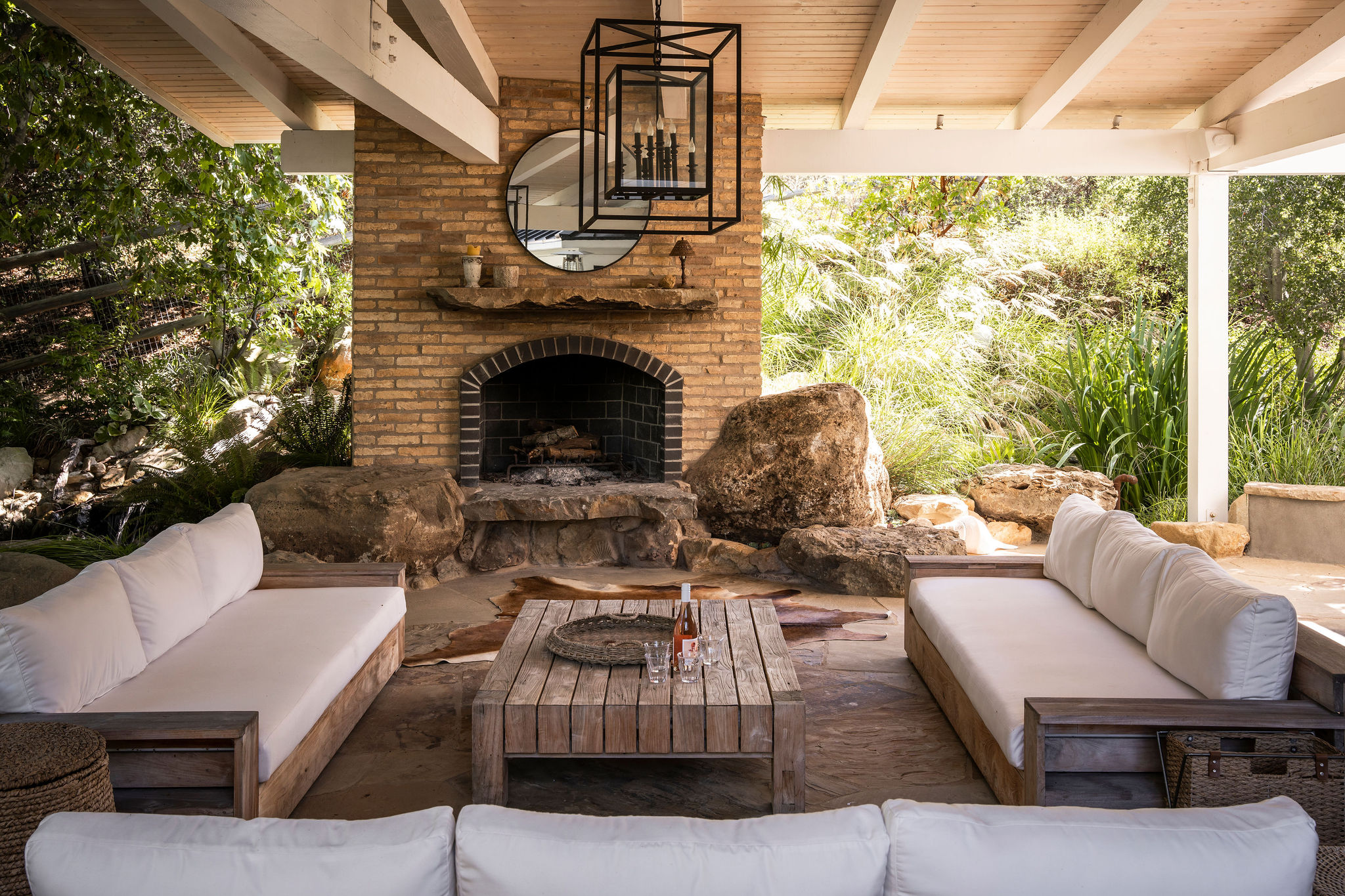 560 Cold Canyon Road Calabasas, CA 91302 - Photo 67 of 84 a outdoor space with patio the couches and a fireplace