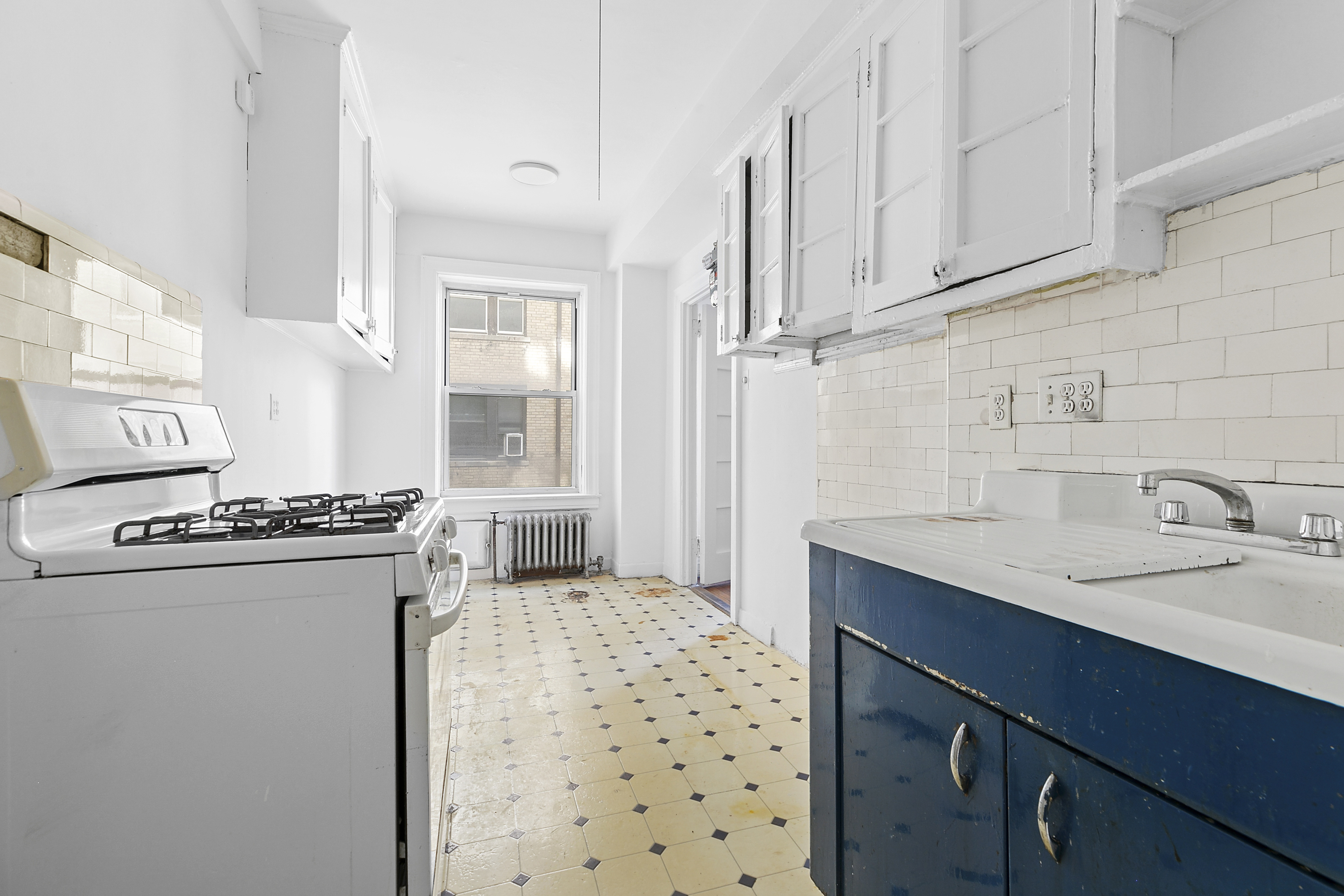 250 West 94th Street, Unit 8J Manhattan, NY 10025 - Photo 10 of 19 a kitchen with stainless steel appliances granite countertop a sink stove and refrigerator