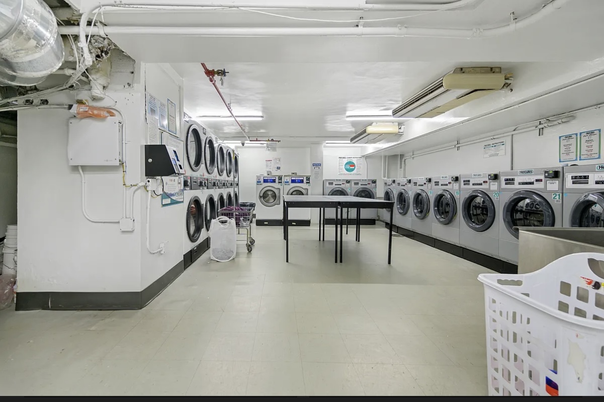 155 East 34th Street, Unit 3B Manhattan, NY 10016 - Photo 9 of 11 a living room with lots of furniture and white walls