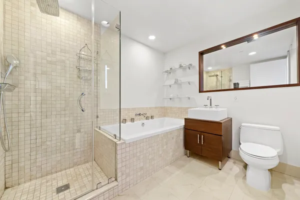 a bathroom with a bathtub toilet sink and mirror