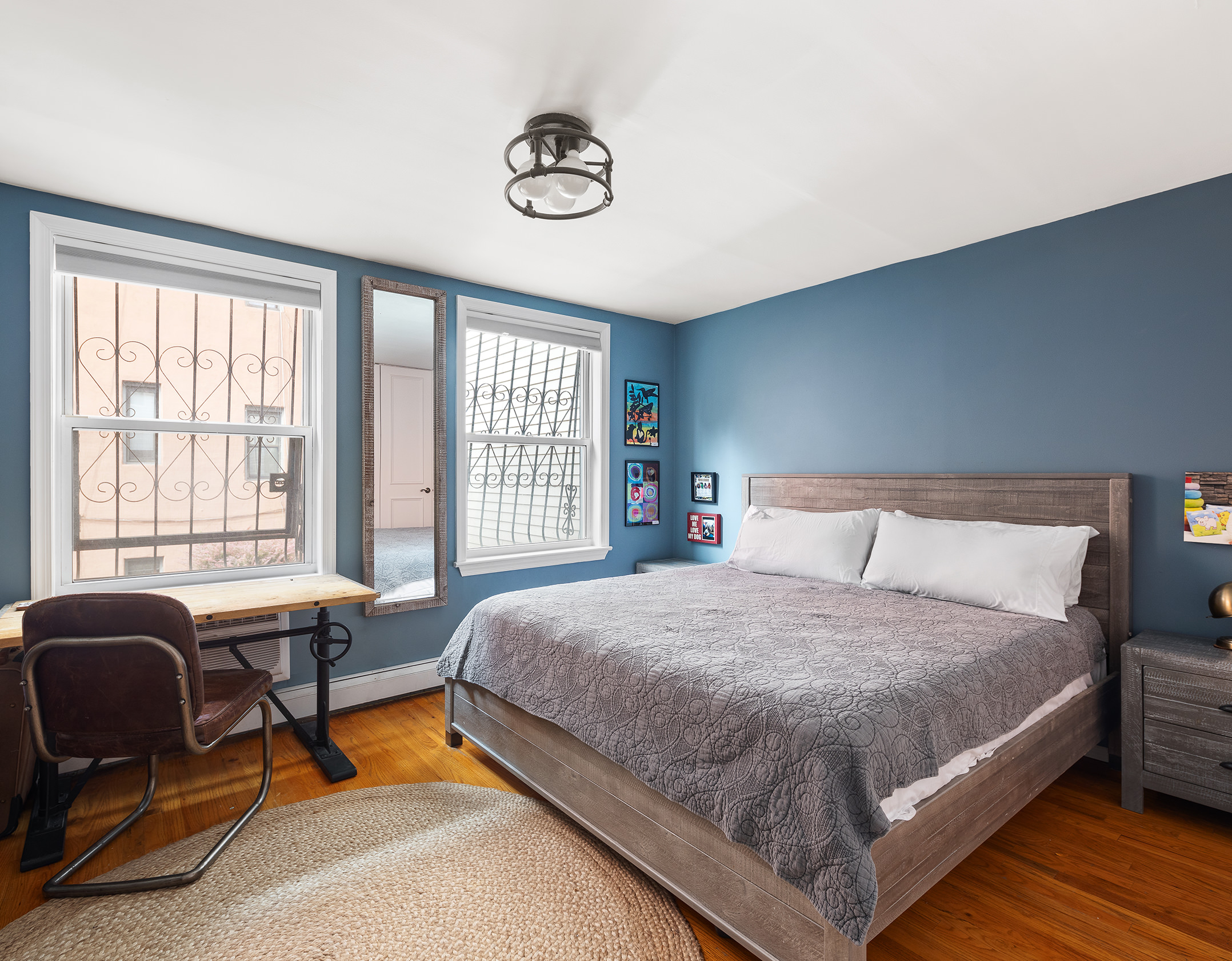 2551 Frederick Douglass Boulevard, Unit B Manhattan, NY 10030 - Photo 5 of 9 a bedroom with a bed a couch and a window