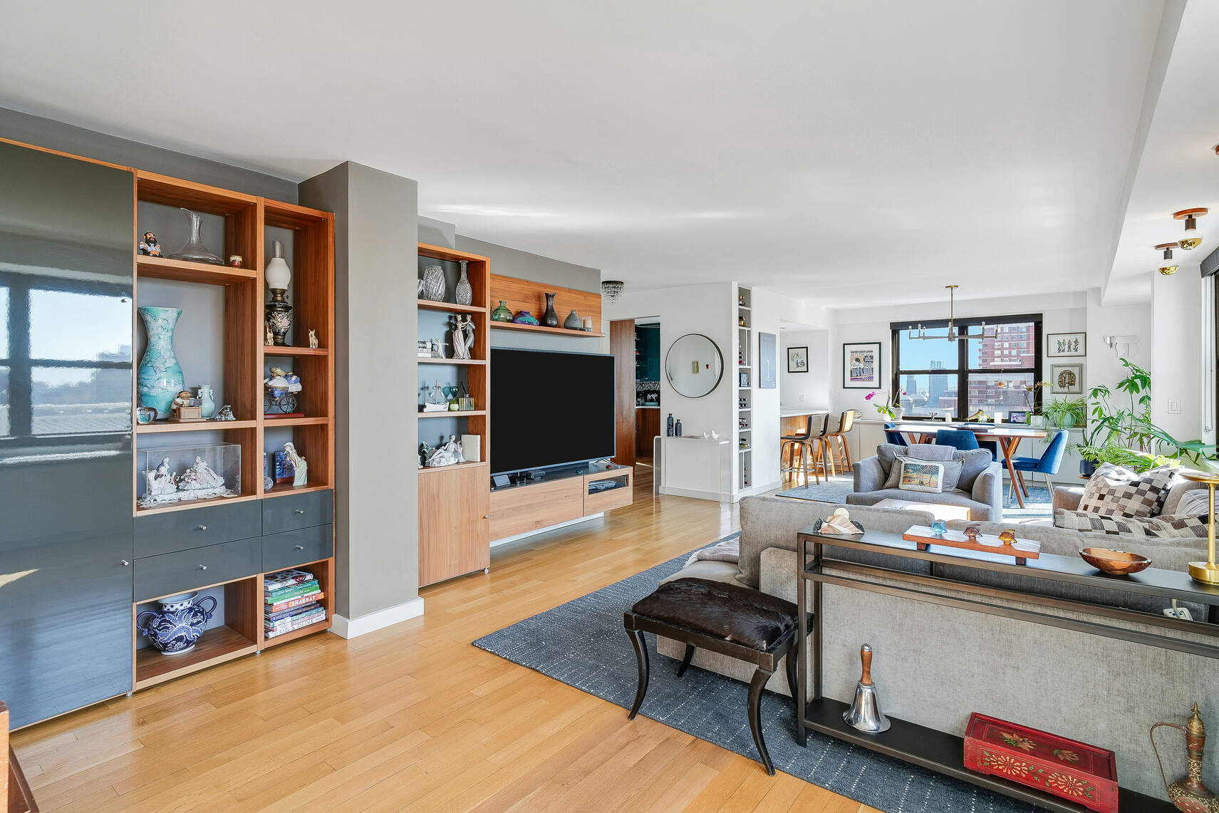 201 East 28th Street, Unit 21BC Manhattan, NY 10016 - Photo 3 of 24 a living room with furniture and a flat screen tv