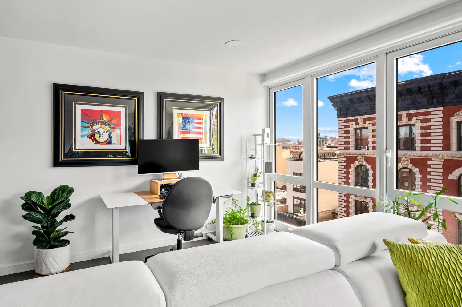 a living room with furniture and a potted plant