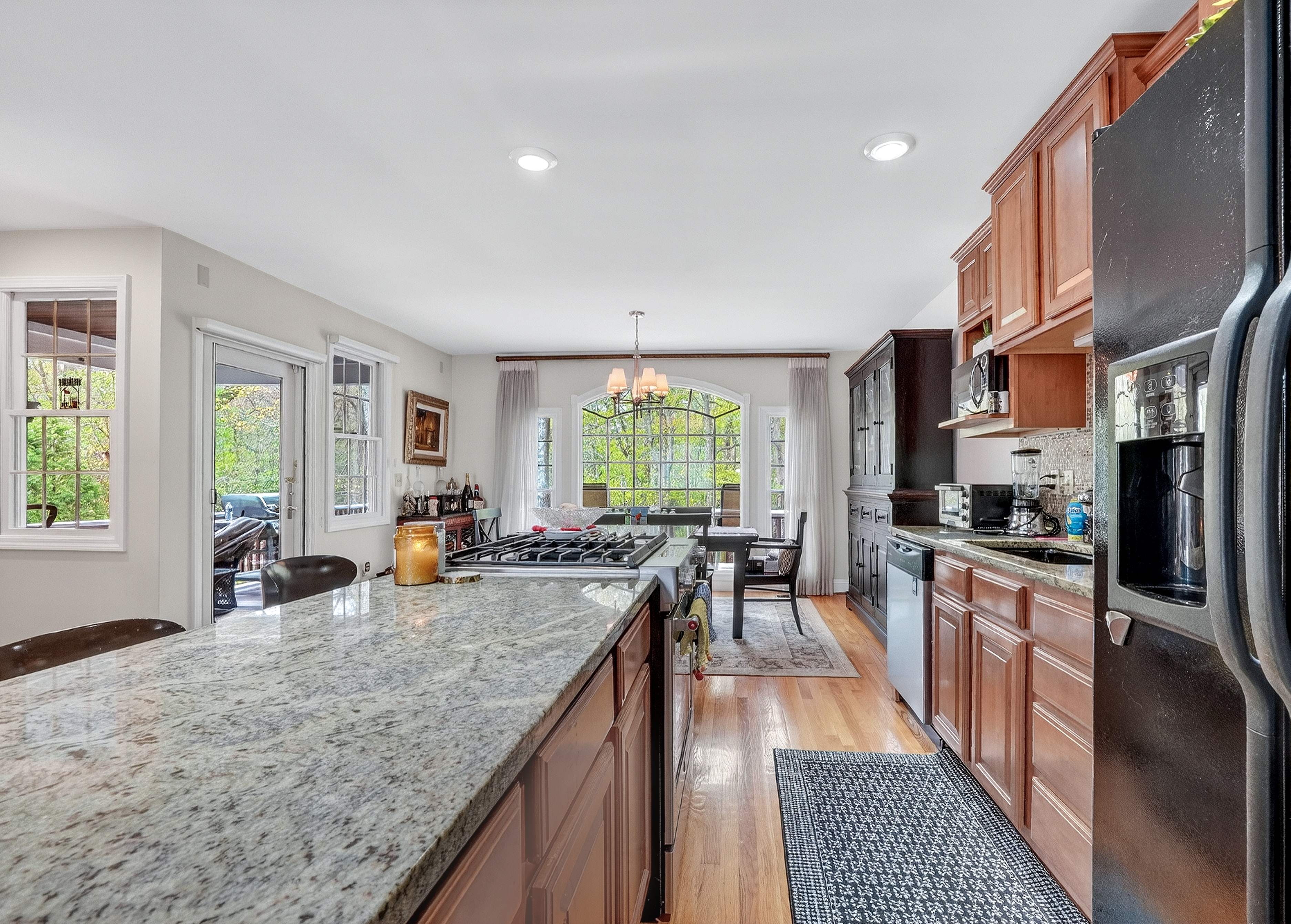 58 Tanglewood Road Newton Center, MA 02459 - Photo 14 of 33 a kitchen with stainless steel appliances granite countertop sink stove top oven and cabinets