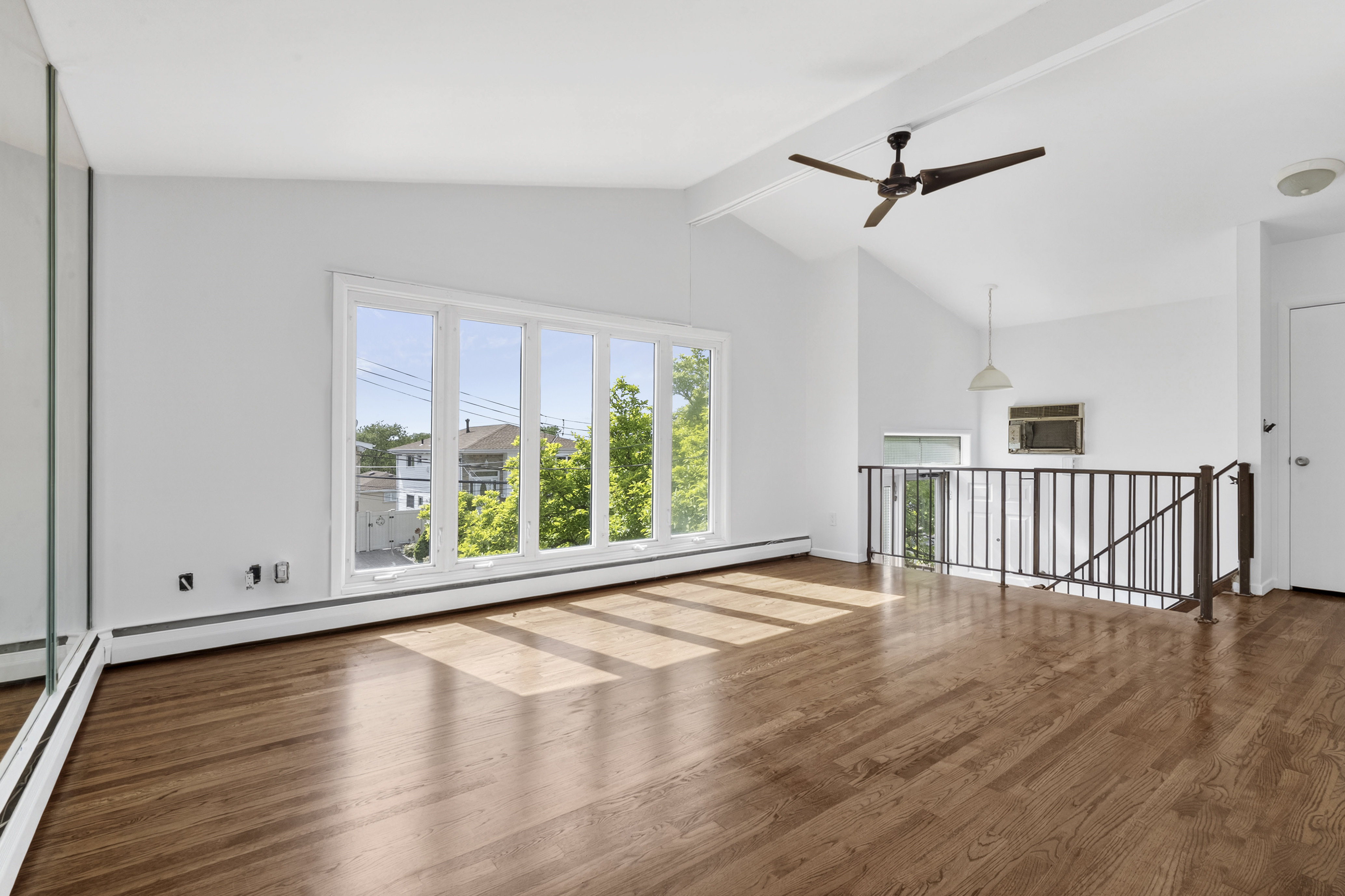 29 Athena Place Staten Island, NY 10314 - Photo 2 of 10 a view of an empty room with wooden floor and a window