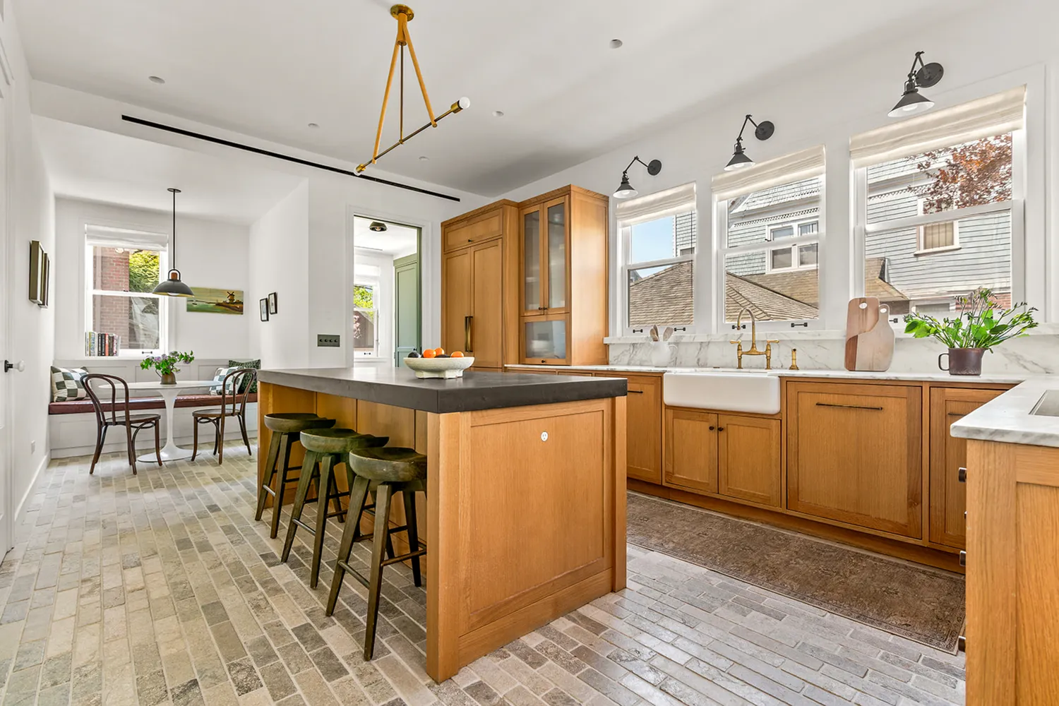 a very nice looking kitchen with a large window a dining table and chairs