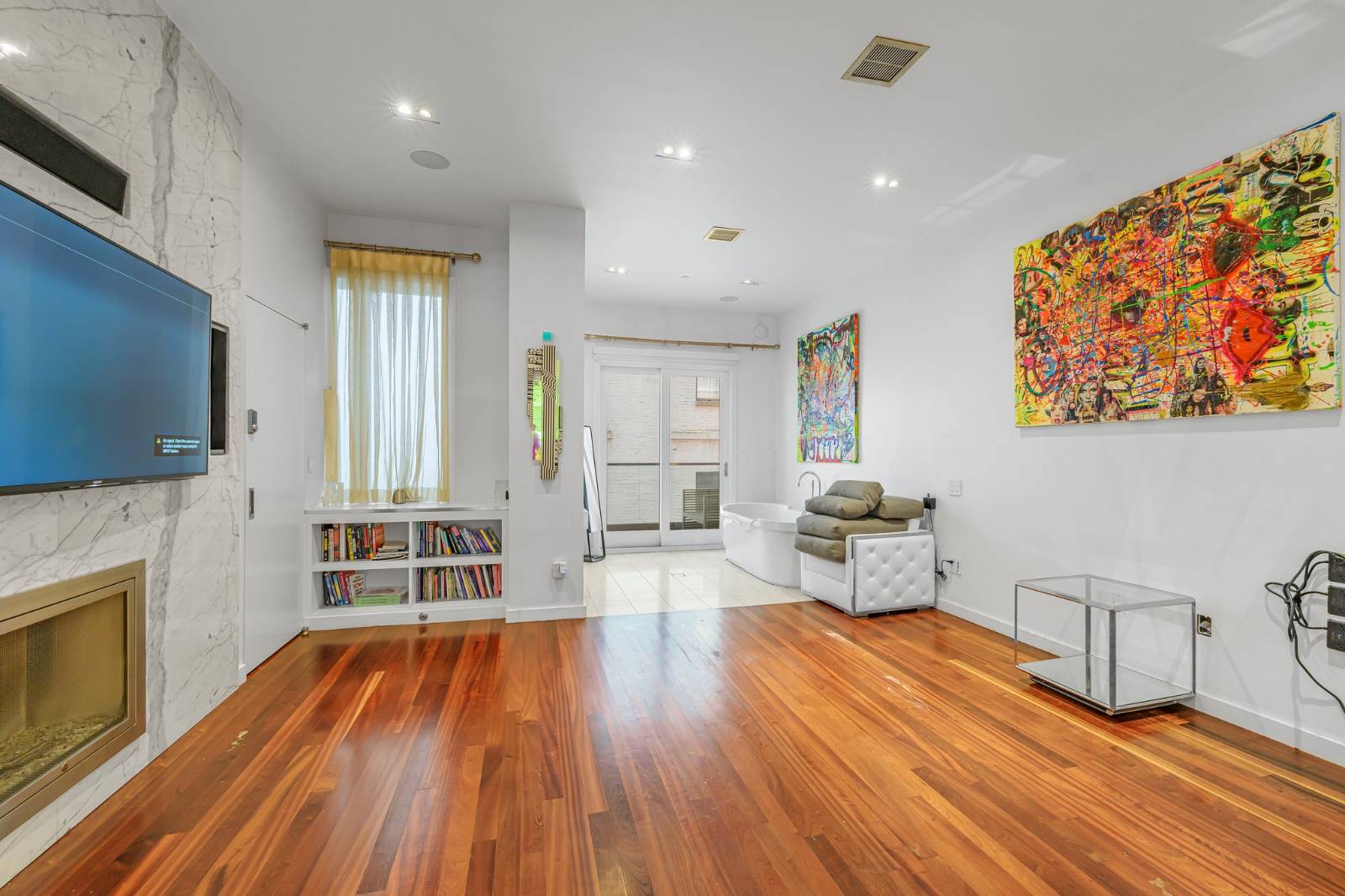 124 East 13th Street, Unit 3 Manhattan, NY 10003 - Photo 16 of 26 a living room with furniture and a fireplace