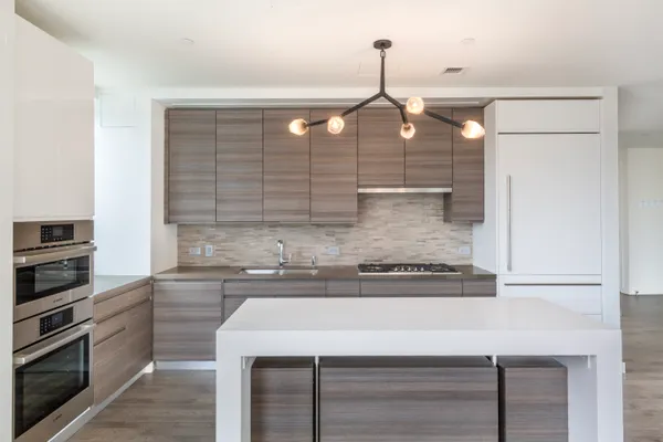 a kitchen with a sink stainless steel appliances and cabinets