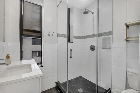a bathroom with a sink toilet and shower