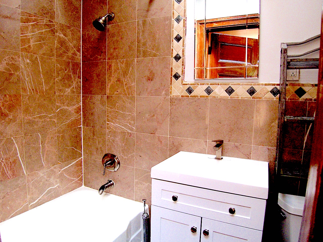 864 Prospect Place, Unit 2 Brooklyn, NY 11216 - Photo 6 of 6 a bathroom with a sink and mirror with bathtub
