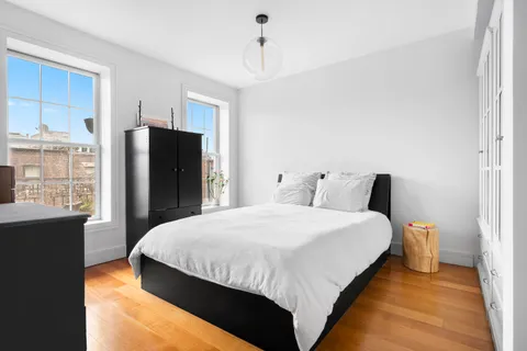 a bedroom with bed and window