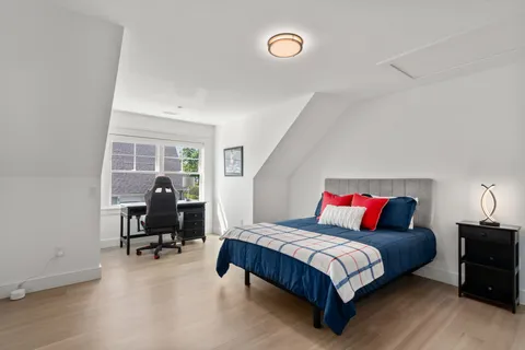 a bedroom with two beds and a window