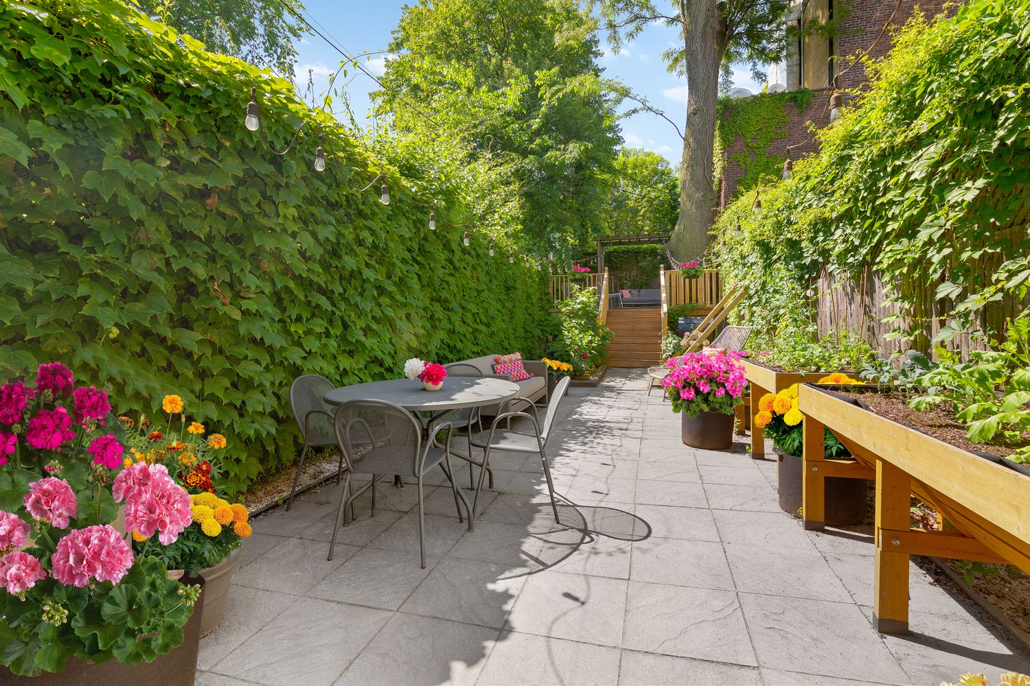 856 St Johns Place Brooklyn, NY 11216 - Photo 11 of 14 a backyard of a house with table and chairs potted plants