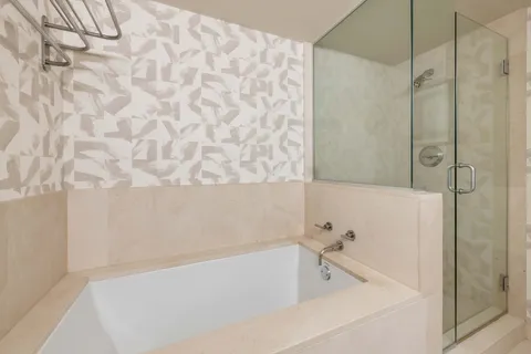 a bathroom with a bathtub and shower