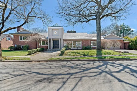a view of a house with a yard and plants