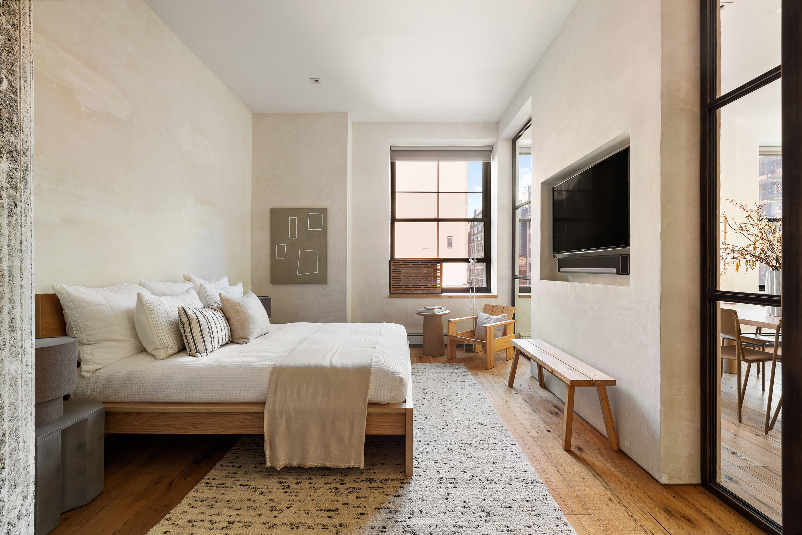 250 Mercer Street, Unit B706B707 Manhattan, NY 10012 - Photo 13 of 25 a living room with furniture and a flat screen tv