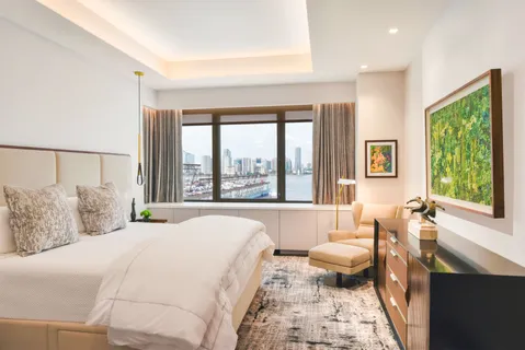 a bedroom with a bed and a chair