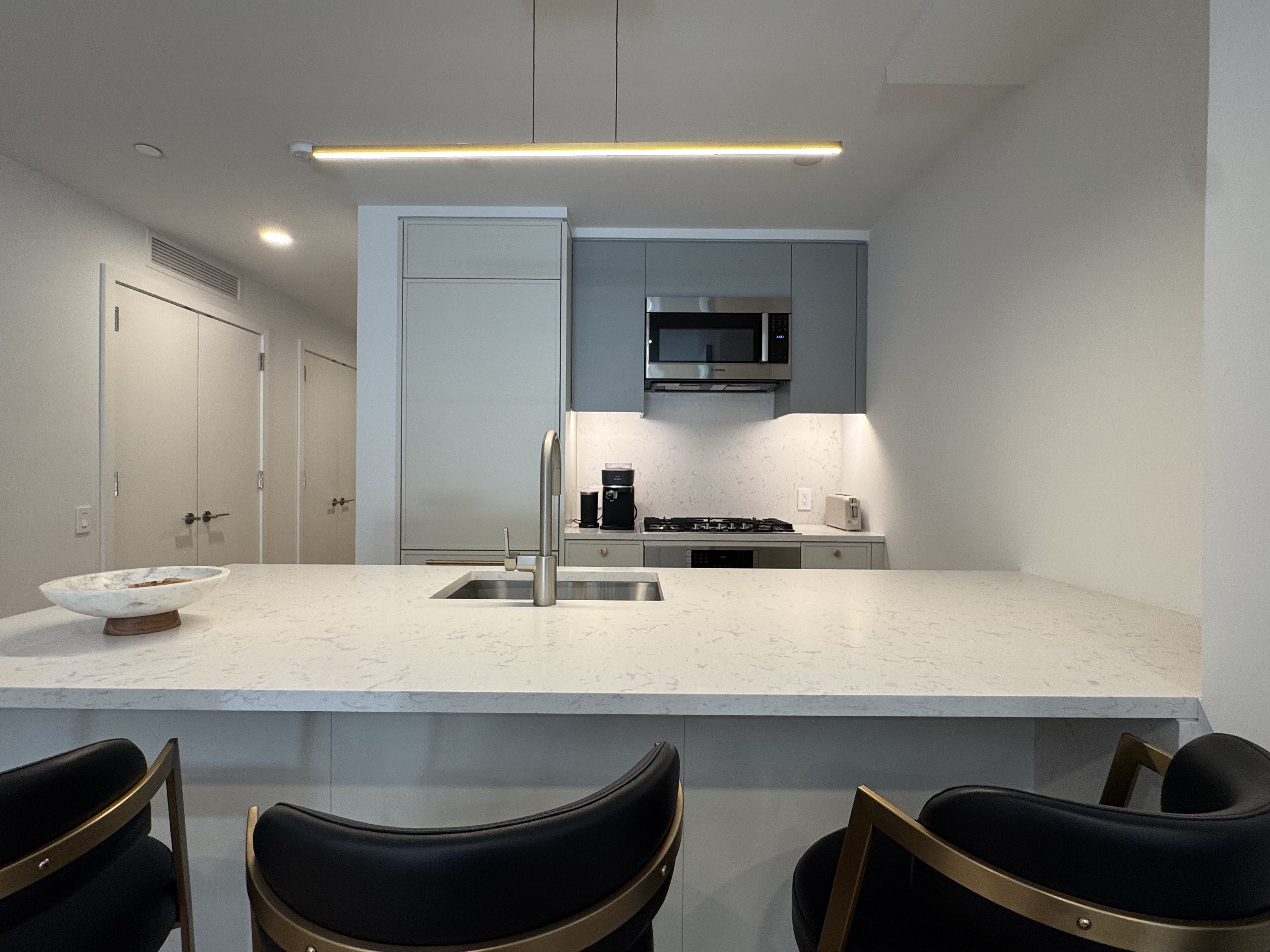 18 West 55th Street, Unit 7B Manhattan, NY 10019 - Photo 9 of 20 a room with a sink and a mirror