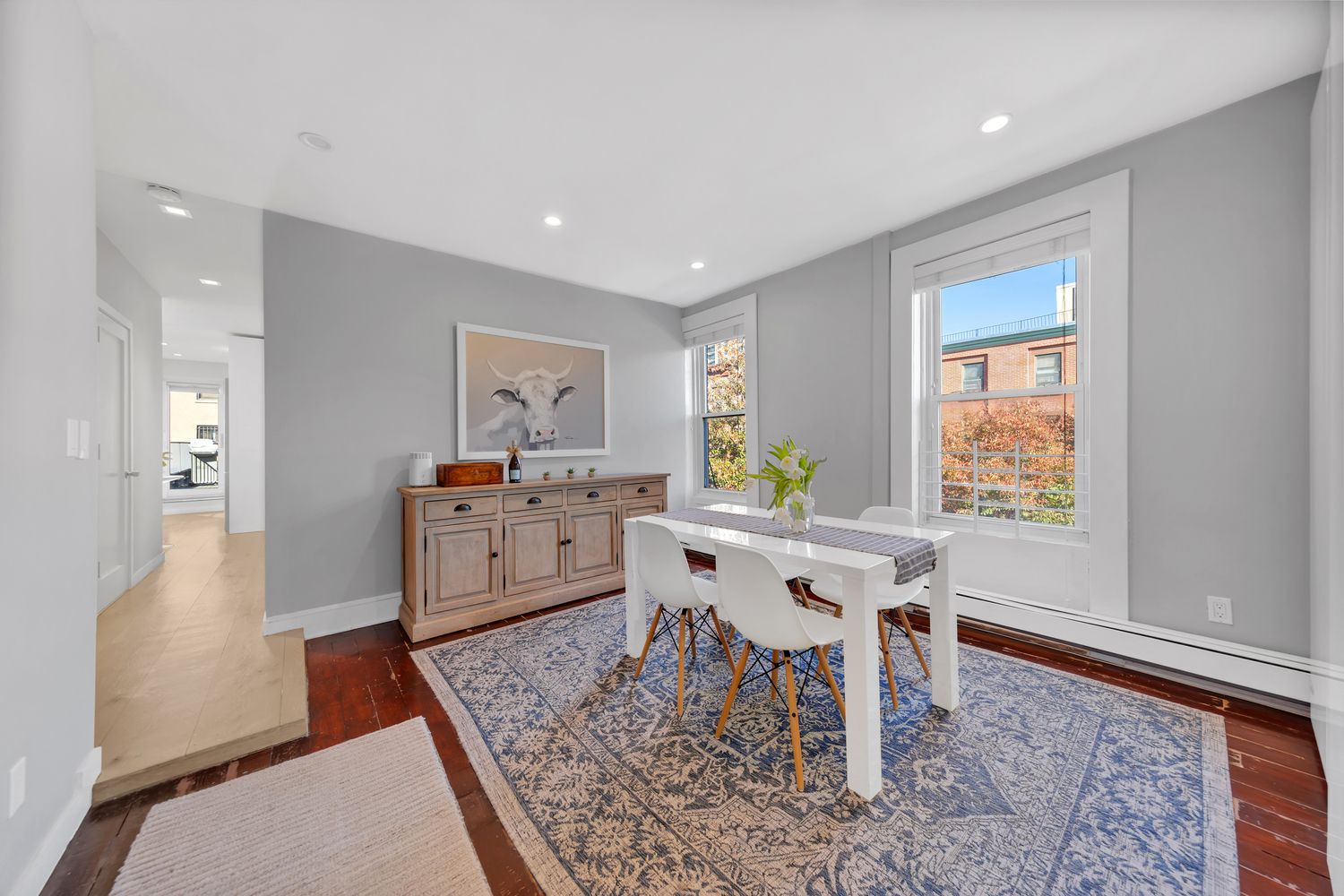 a living room with dining room and wooden floor