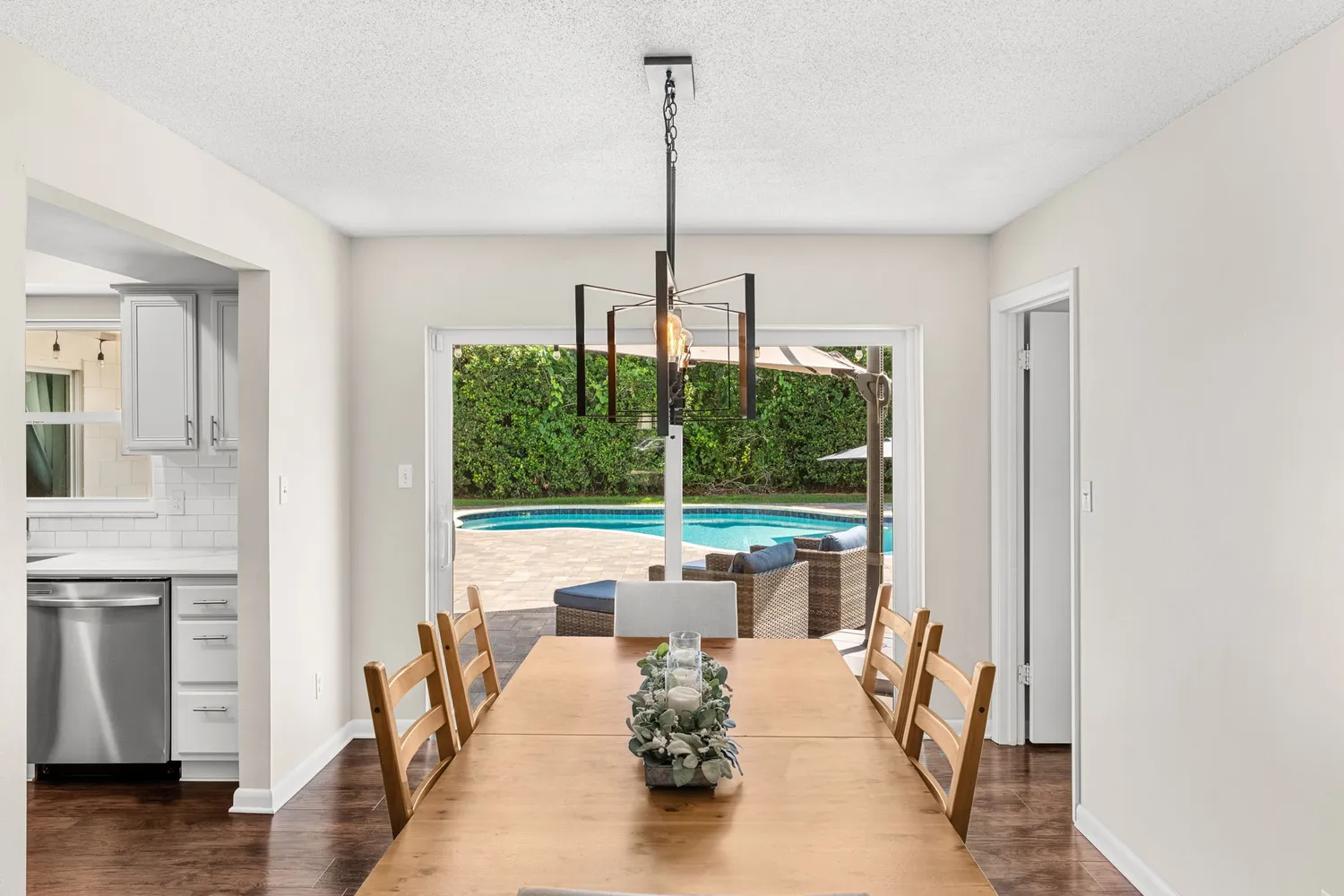 a living room with furniture a wooden floor and a chandelier
