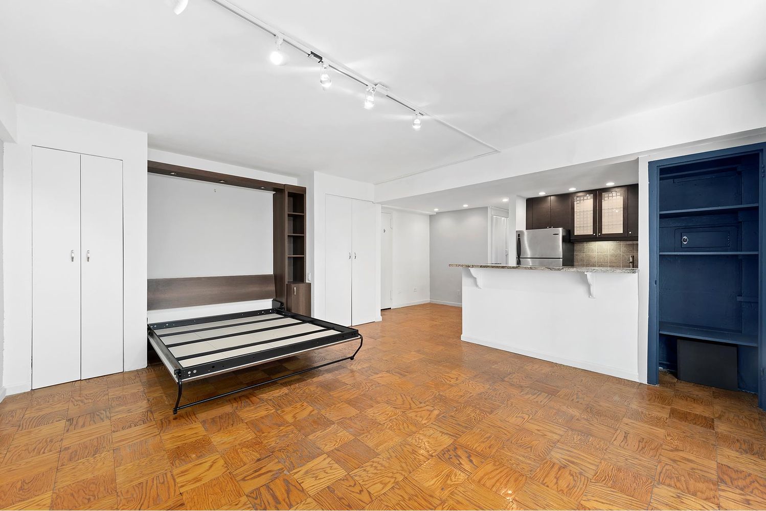 40 Sutton Place, Unit 8D Manhattan, NY 10022 - Photo 6 of 12 a view of livingroom with a flat screen tv cabinet and refrigerator