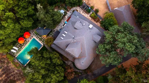 an aerial view of house with yard and outdoor seating