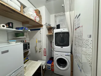 a view of a storage and utility room with washer and dryer