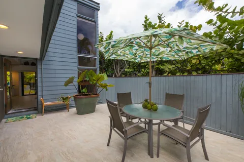 a backyard of a house with table and chairs