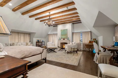 a bedroom with a bed a couch and potted plant on the counter