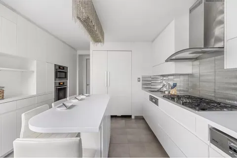 a kitchen with stainless steel appliances a sink and a stove