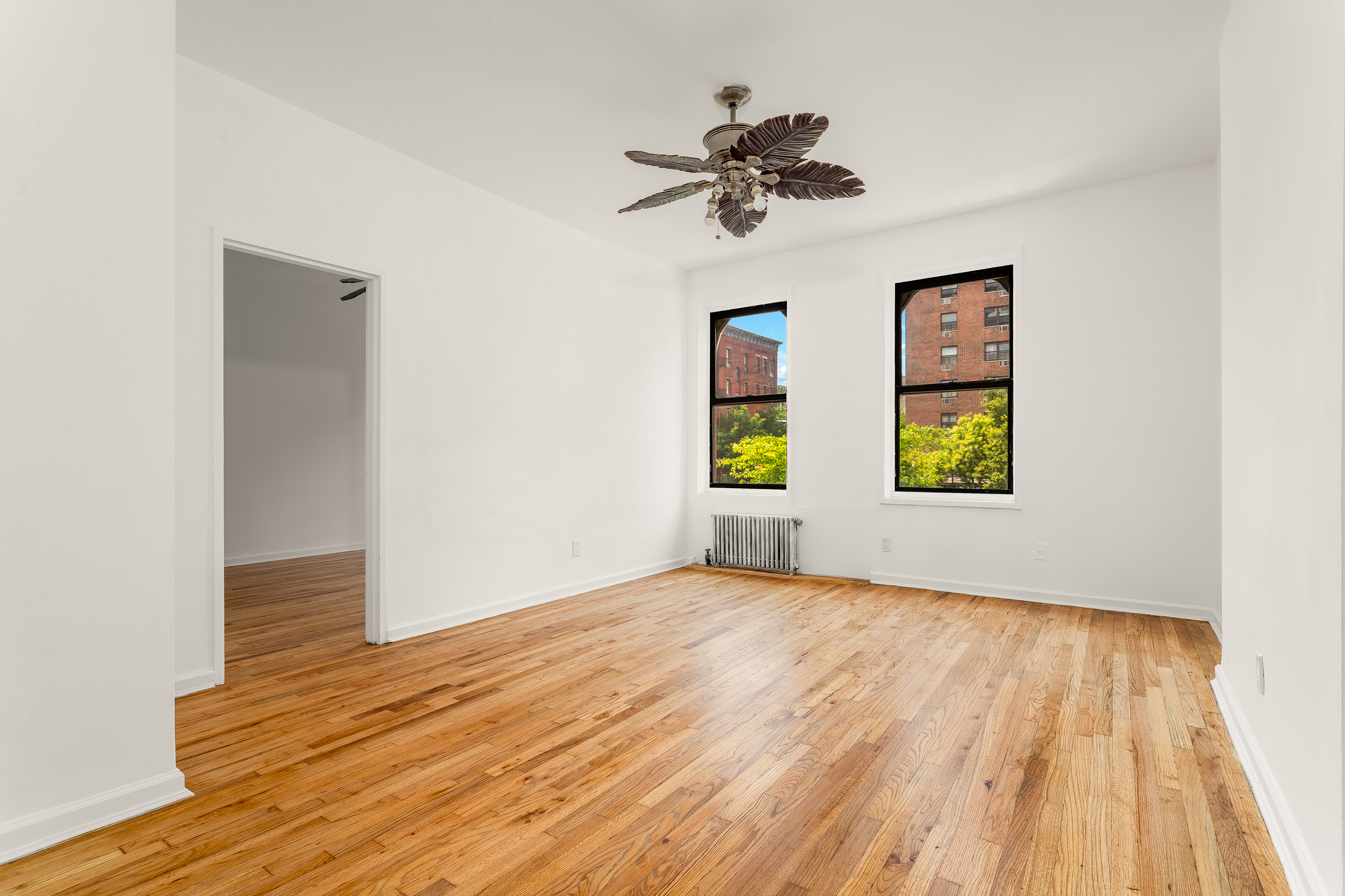 157 West 123rd Street, Unit 2A Manhattan, NY 10027 - Photo 3 of 16 wooden floor in an empty room