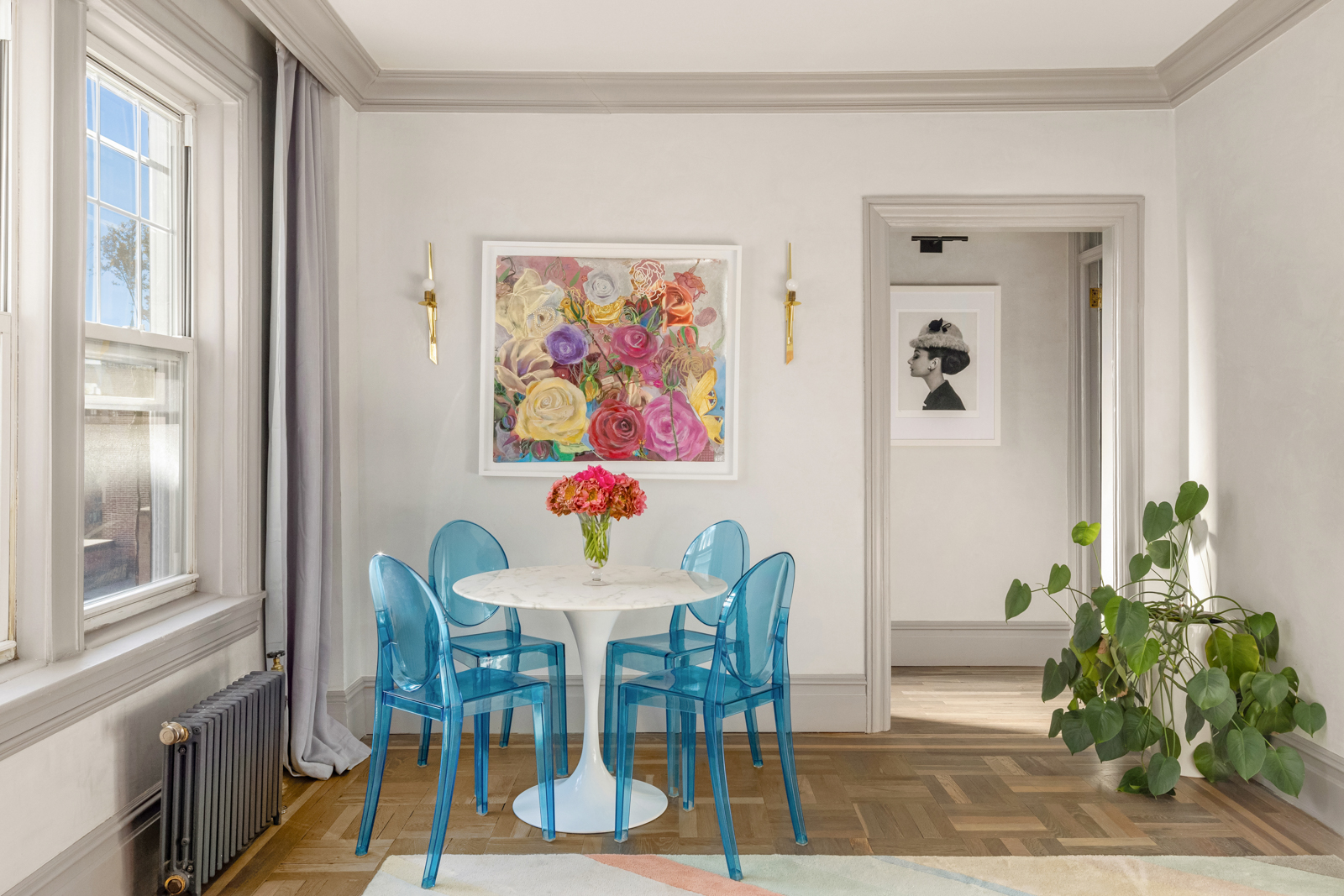15 West 11th Street, Unit 9A Manhattan, NY 10011 - Photo 2 of 9 a view of a dining room with furniture a potted plant and wooden floor