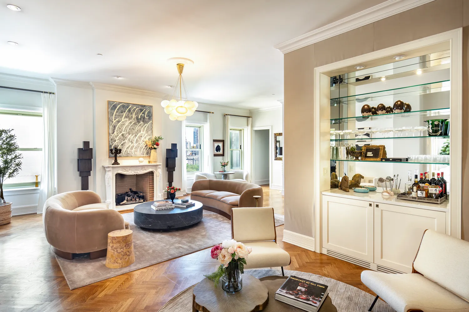 a living room with furniture a fireplace and a large mirror