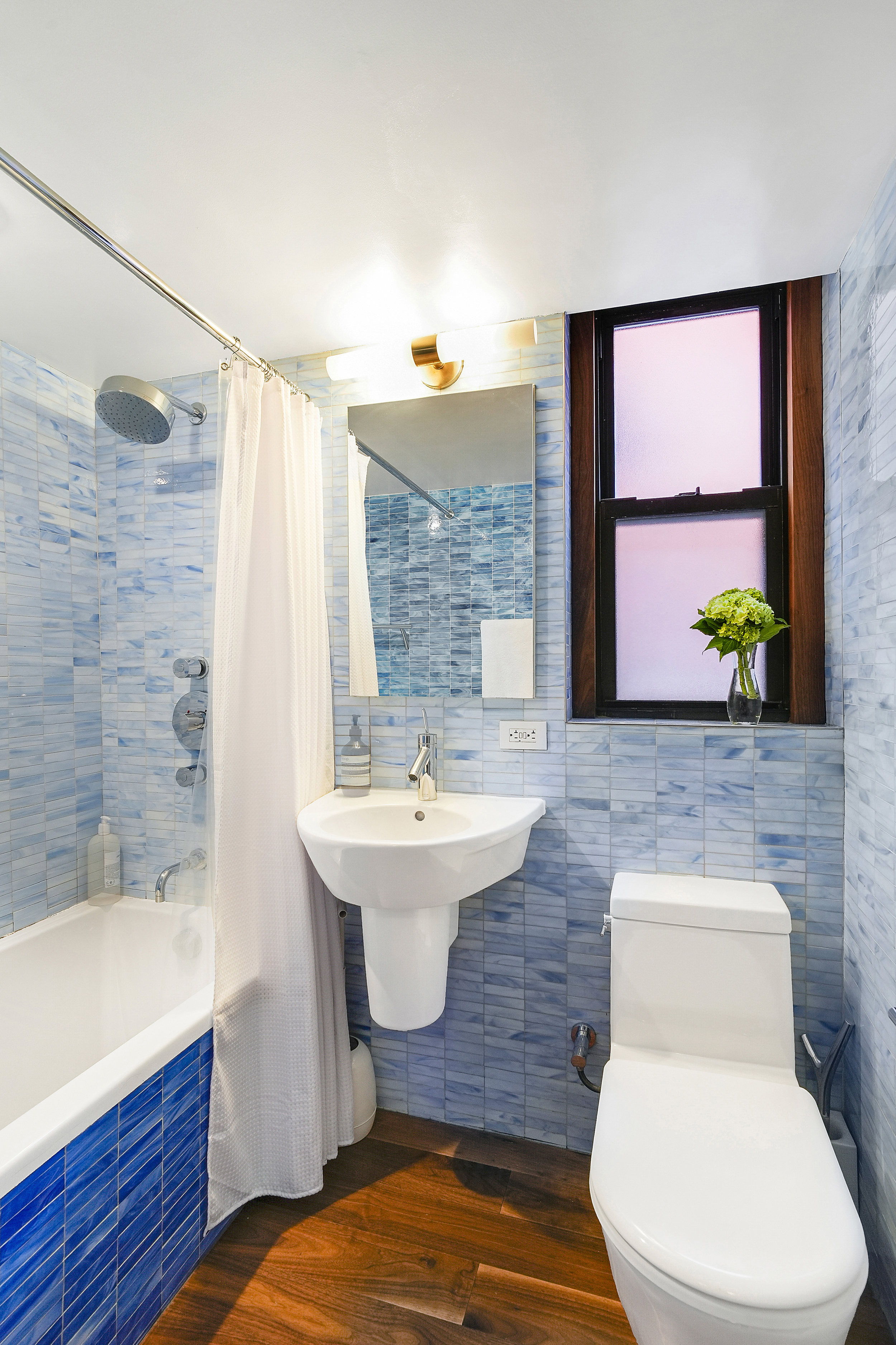 220 East 54th Street, Unit 11H Manhattan, NY 10022 - Photo 8 of 13 a bathroom with a sink and mirror
