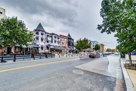 a view of a street with cars parked in front of it
