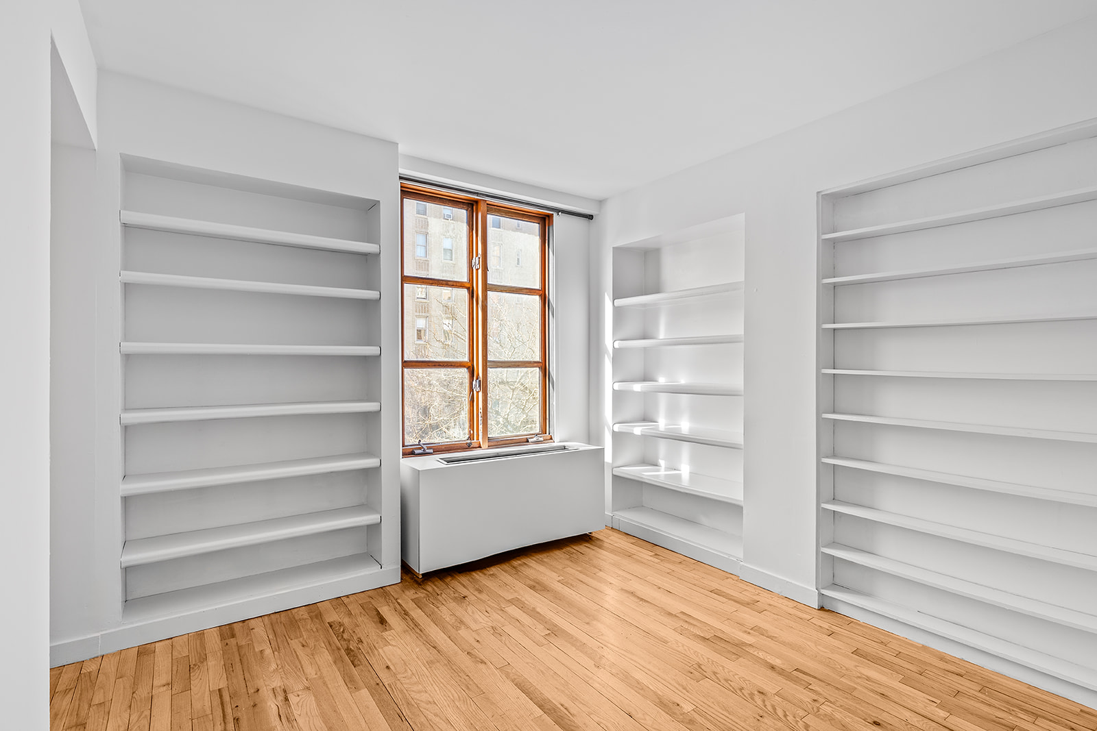 126 Waverly Place, Unit 2F Manhattan, NY 10011 - Photo 6 of 11 a view of an empty room with a window and wooden floor