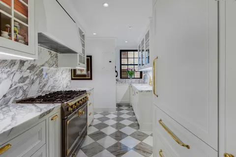 a kitchen with stainless steel appliances granite countertop a stove and a sink