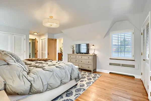 a bedroom with a bed and a large window
