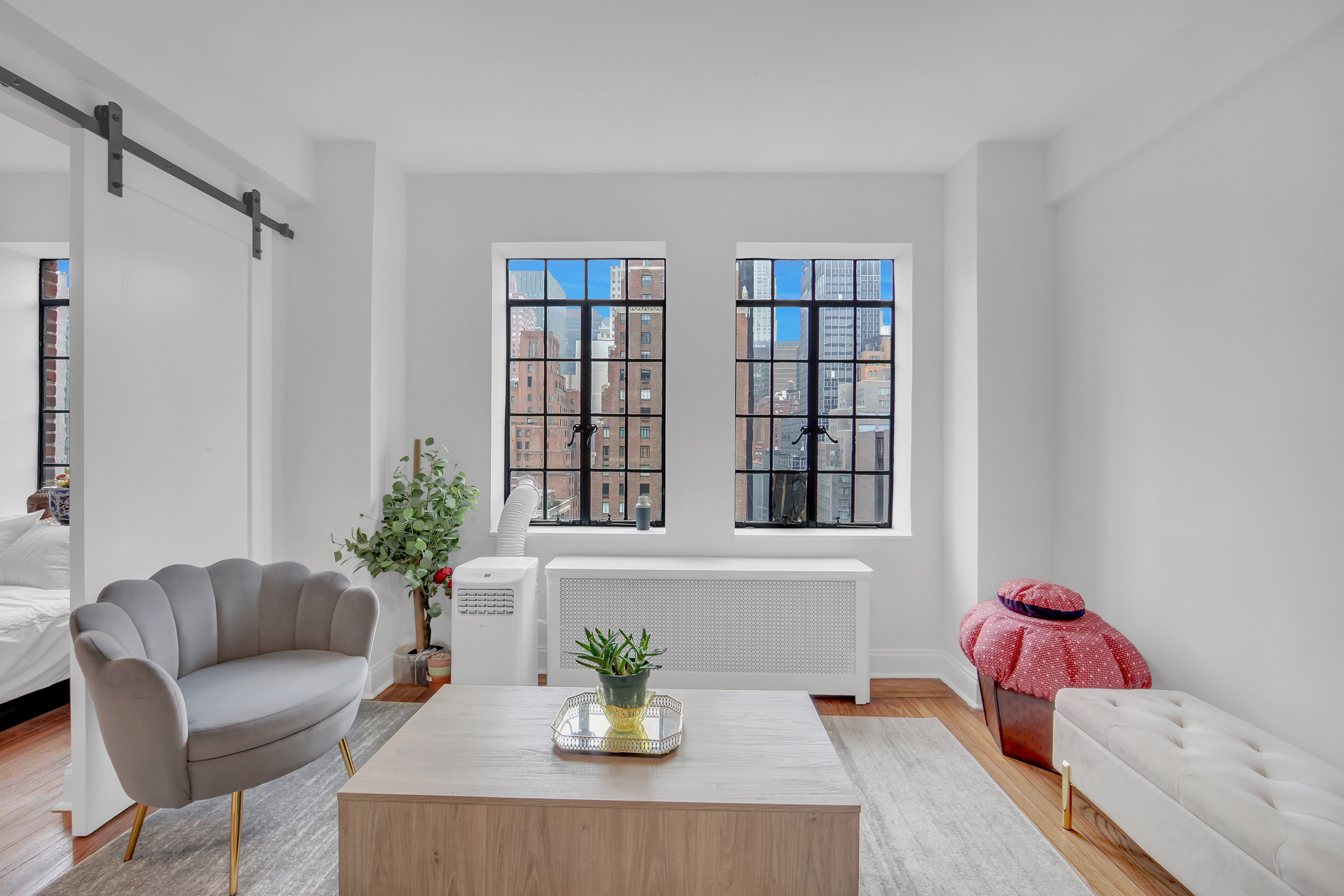 25 Tudor City Place, Unit 1405 Manhattan, NY 10017 - Photo 4 of 21 a living room with furniture and flowers