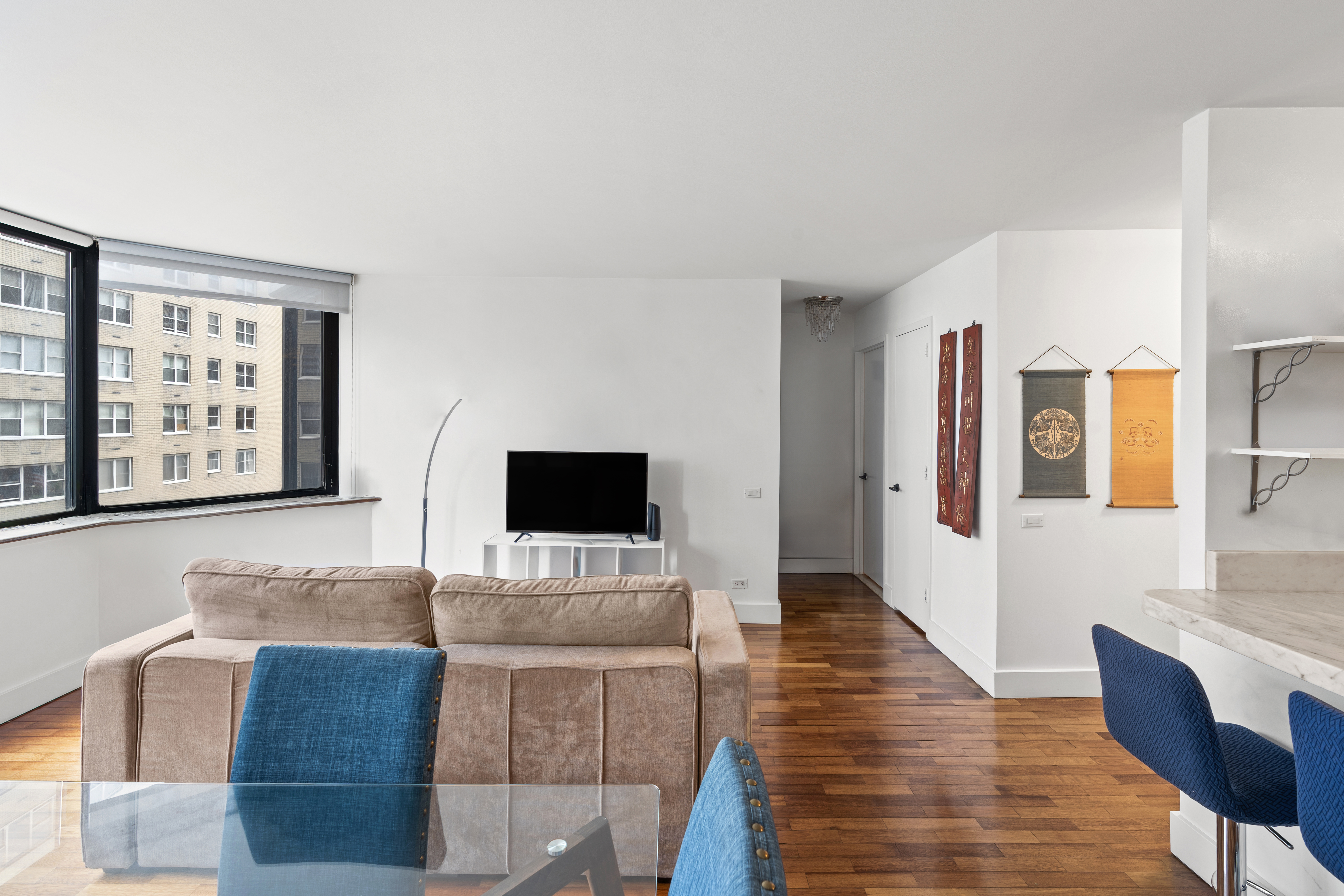 330 East 75th Street, Unit 4K Manhattan, NY 10021 - Photo 3 of 9 a living room with furniture and a flat screen tv