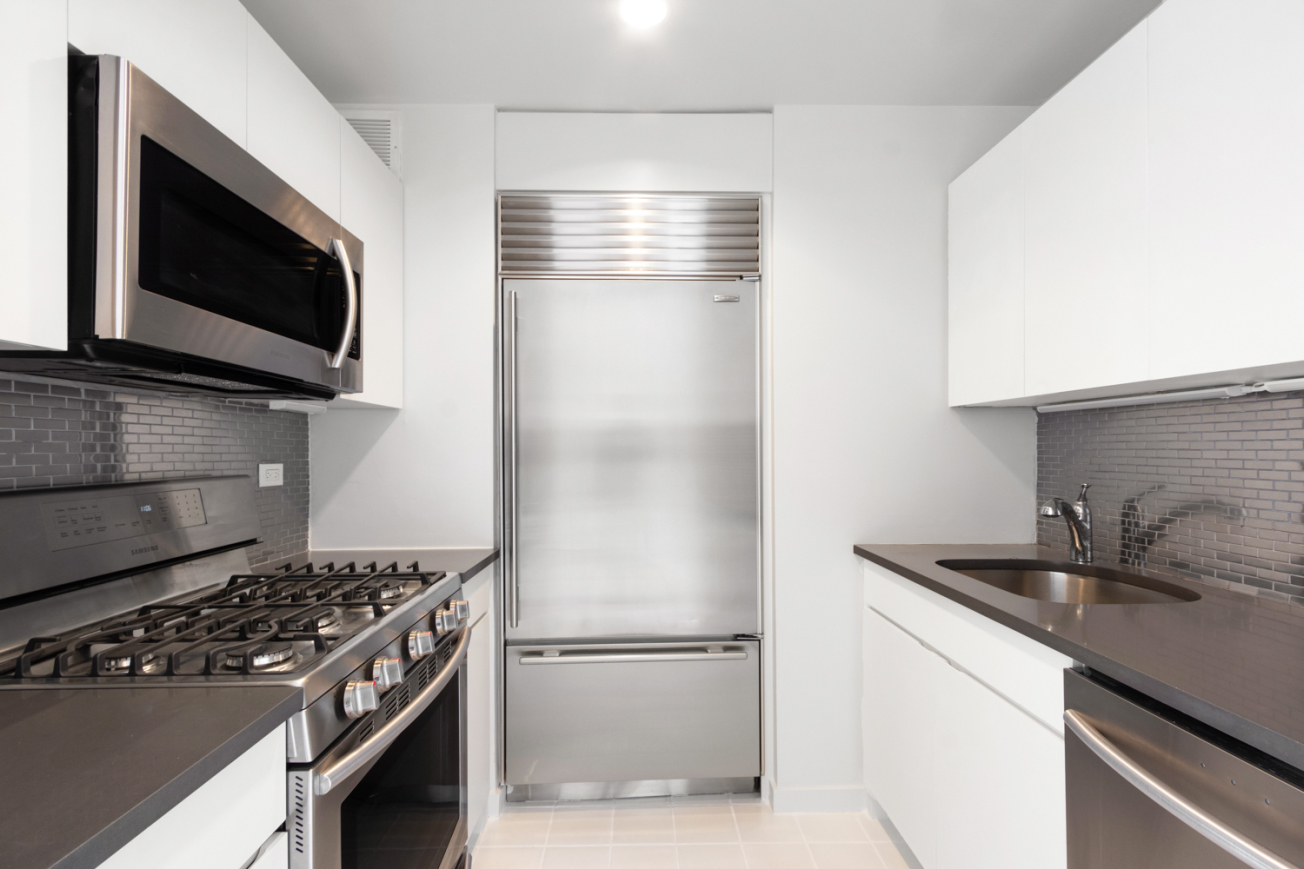160 West 66th Street, Unit 20F Manhattan, NY 10023 - Photo 4 of 7 a kitchen with a stove and a microwave