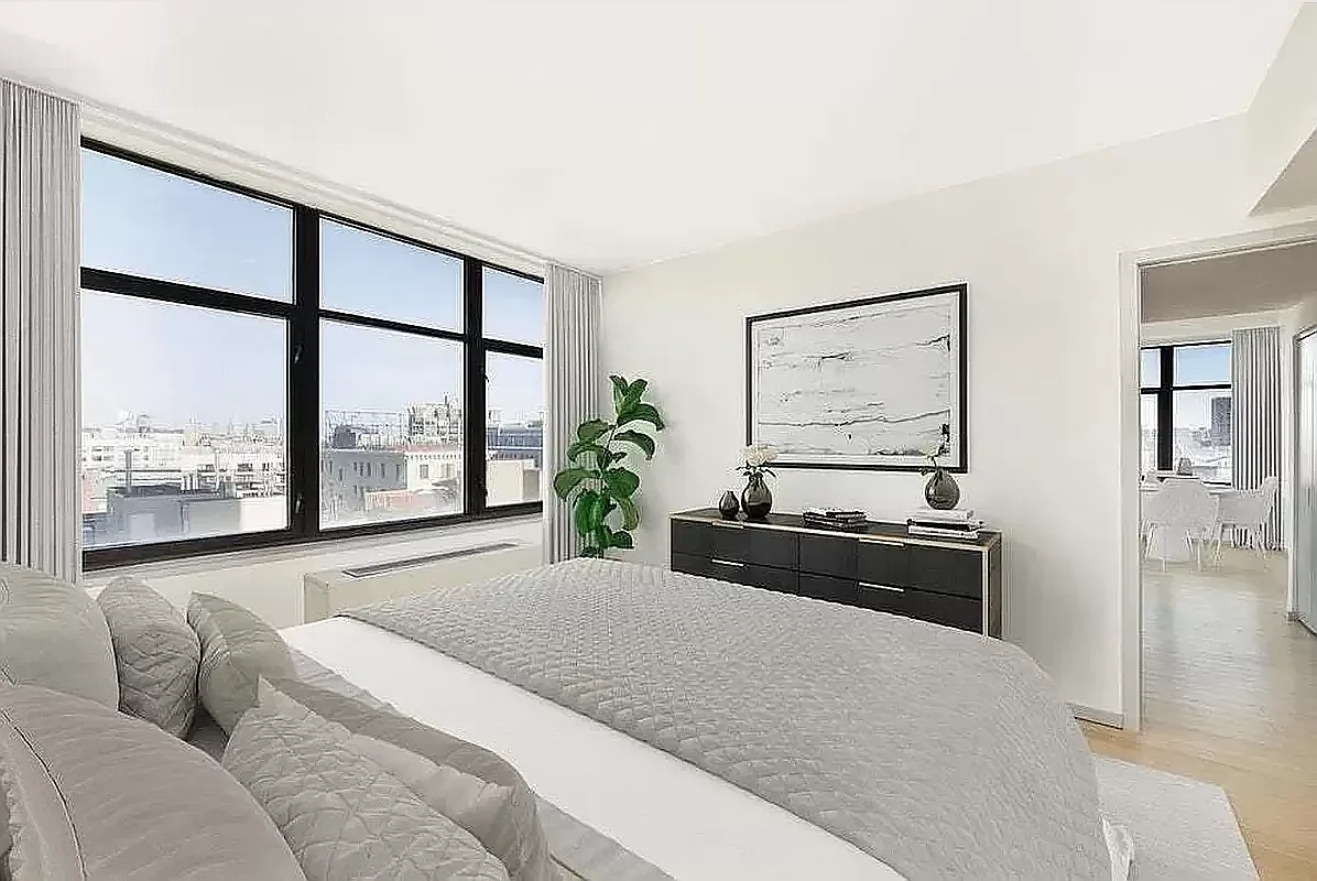 424 Bedford Avenue, Unit 5C Brooklyn, NY 11249 - Photo 2 of 11 a bedroom with a large bed and a large window