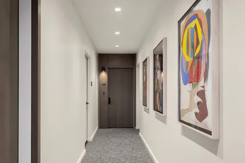 a view of a hallway with wooden door