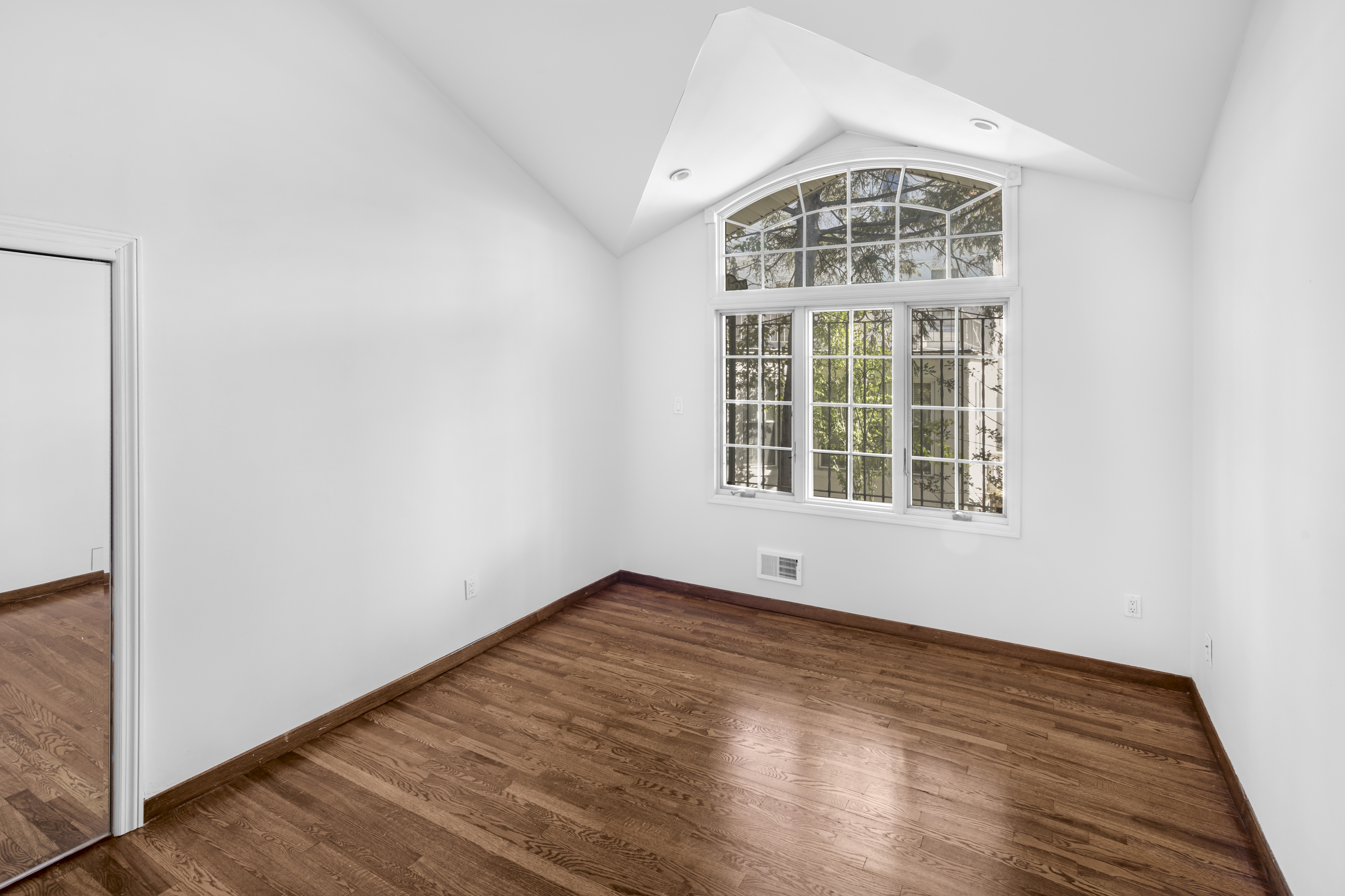 60 82nd Street Brooklyn, NY 11209 - Photo 10 of 19 an empty room with wooden floor and windows