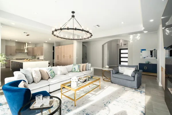 a living room with furniture and a chandelier