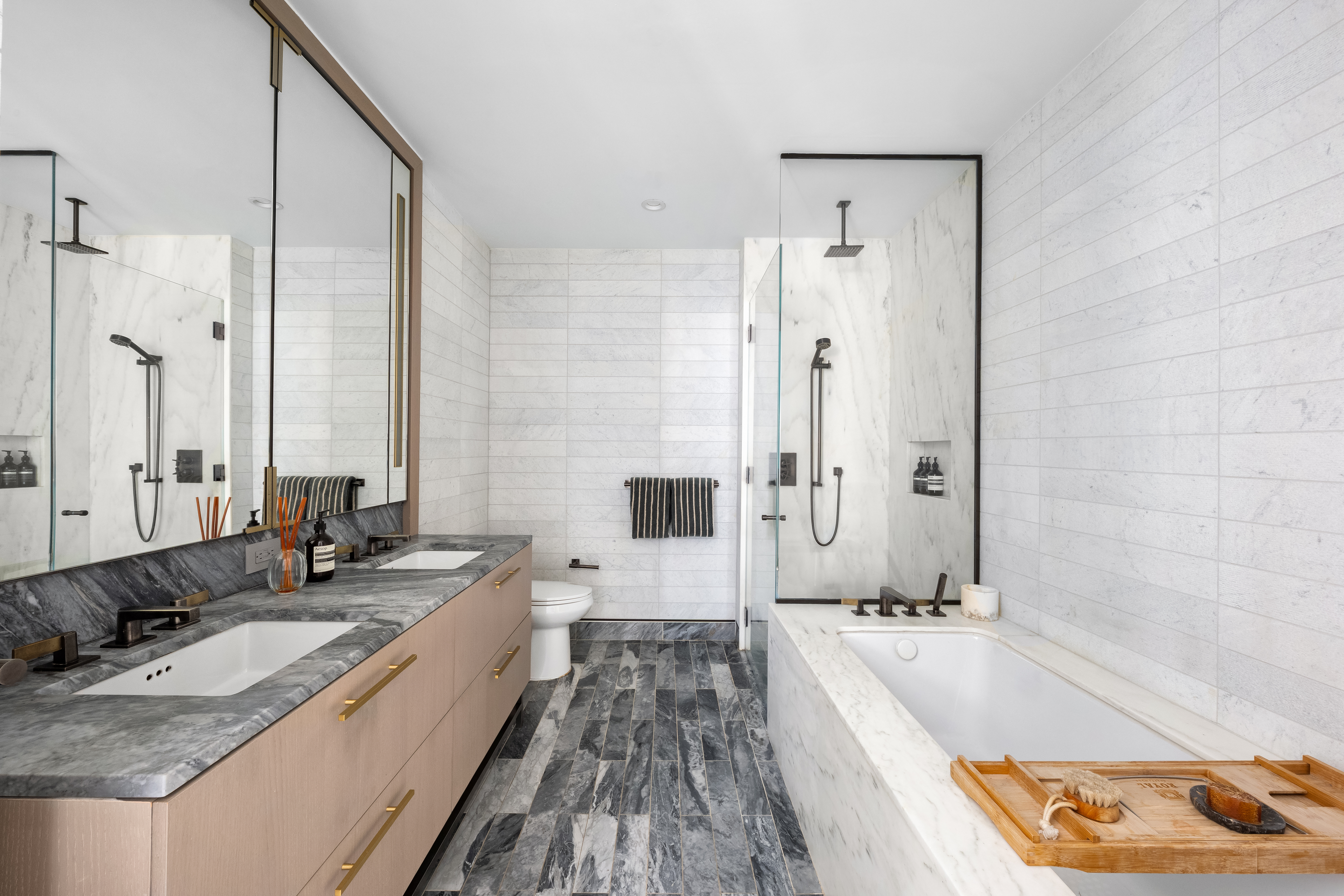 91 Leonard Street, Unit 16B Manhattan, NY 10013 - Photo 8 of 20 a bathroom with a granite countertop tub sink and mirror